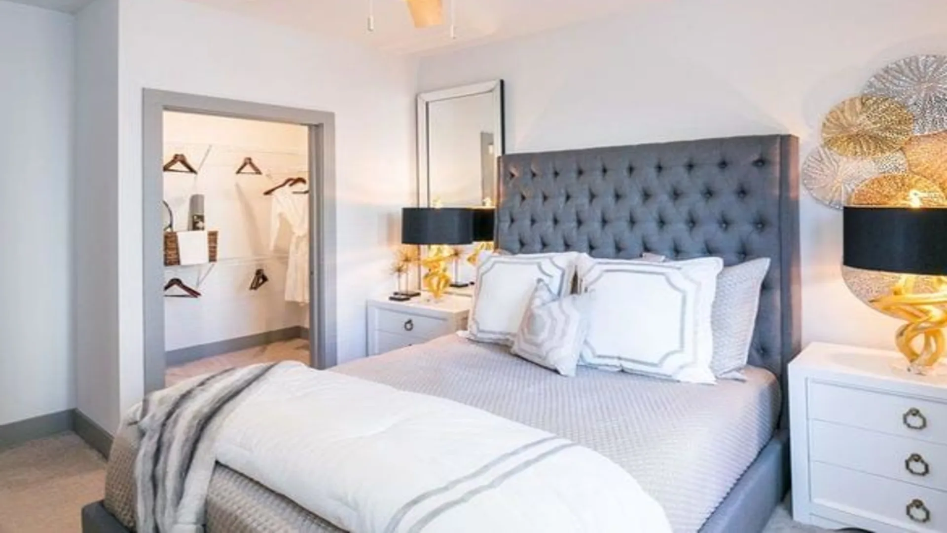 a bedroom with a white bed and gray headboard at The Argon