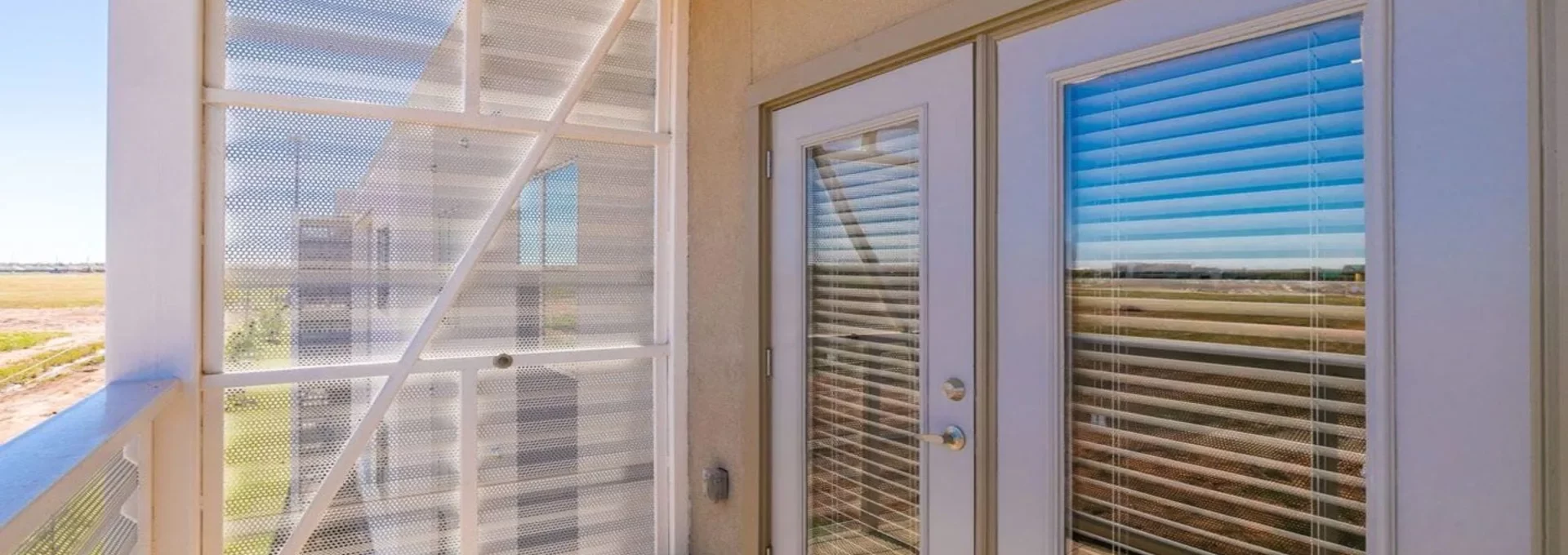 a balcony with sliding glass doors and a view of the outside at The Argon