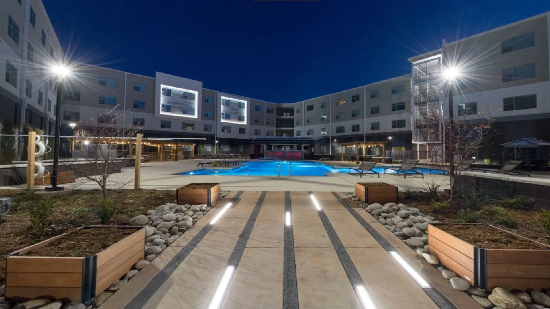 the courtyard at night with a pool and lighting at The Argon